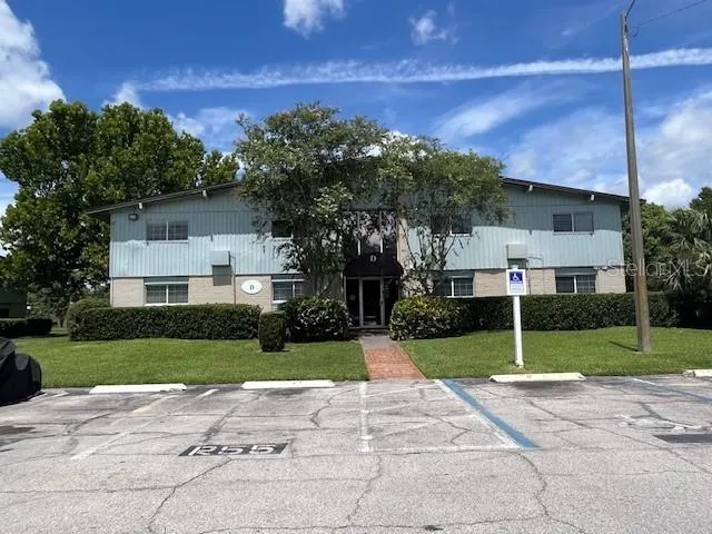 a view of a house with a yard and tree s