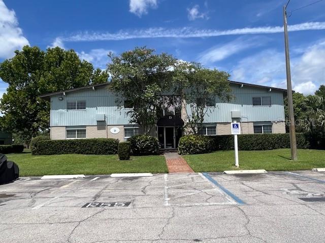 a view of a house with a yard and tree s
