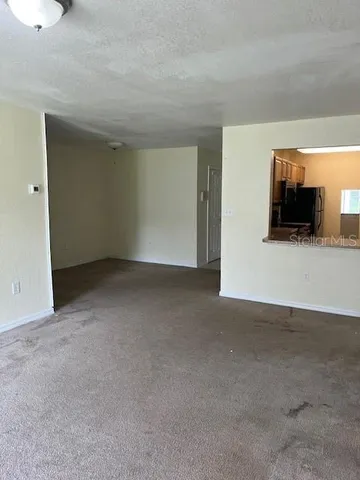 a view of an empty room with a fireplace
