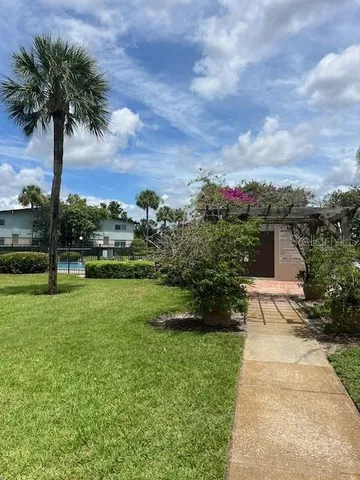 a view of a garden with a building in the background