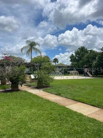 a view of a swimming pool with a yard