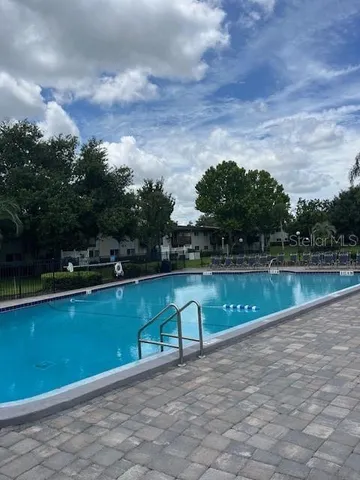 a view of a swimming pool with a yard