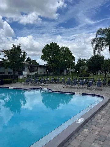 a view of a green field with wooden fence
