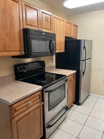 a kitchen with granite countertop cabinets and steel stainless steel appliances