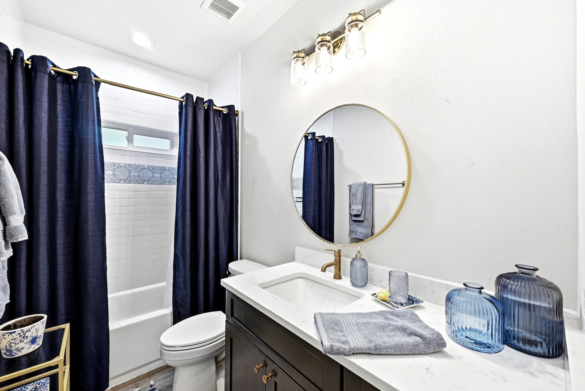 2889 Old McMahan Road Lockhart, TX 78644 - Photo 23 of 33 Modern bath features a clean white vanity with ample counter space and a sleek round mirror.