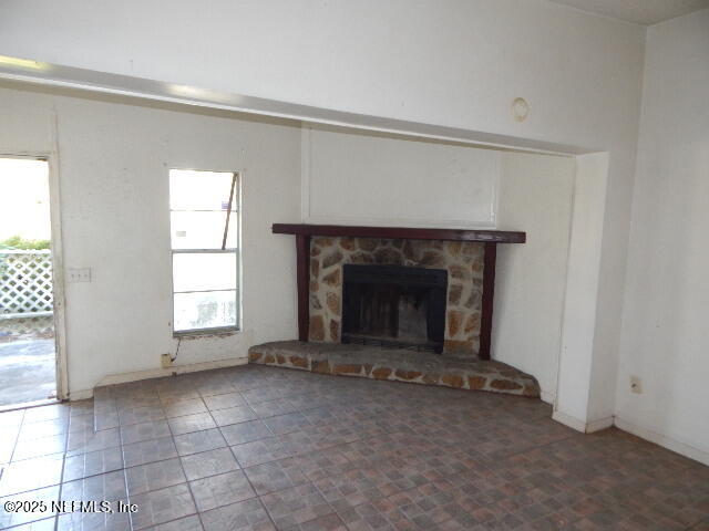 9790 Hogan Road Jacksonville, FL 32246 - Photo 2 of 11 an empty room with a fireplace