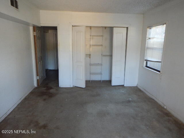 9790 Hogan Road Jacksonville, FL 32246 - Photo 4 of 11 wooden floor and closet in a room
