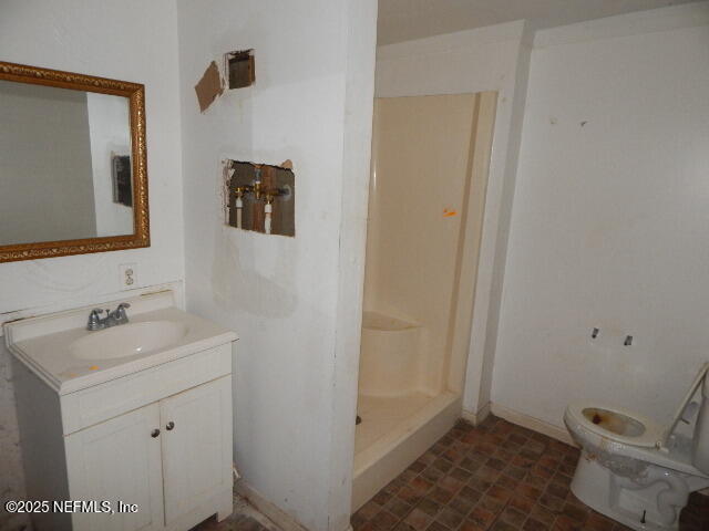 9790 Hogan Road Jacksonville, FL 32246 - Photo 5 of 11 a bathroom with a toilet sink and mirror