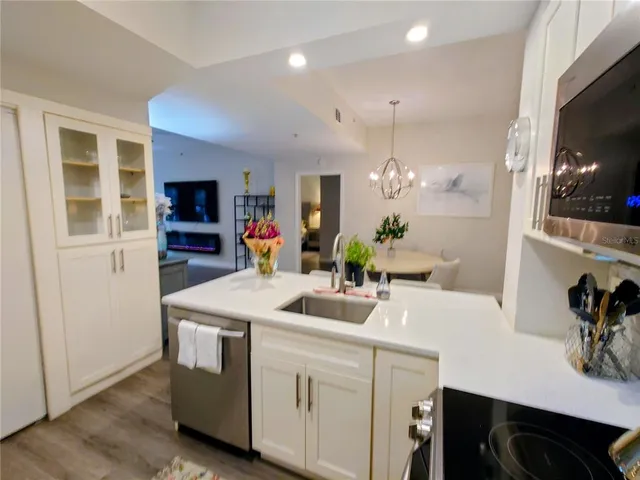 a kitchen that has a sink and a stove in it