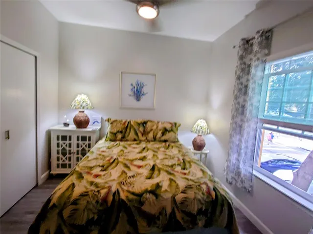 a bed sitting in a bedroom next to a window