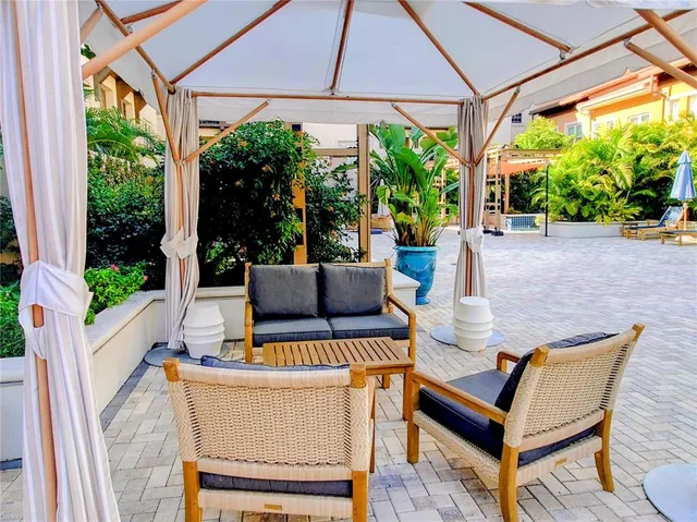 a view of a patio with a table chairs and a porch
