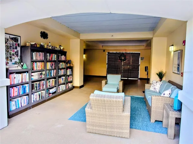 a living room with furniture and a book shelf