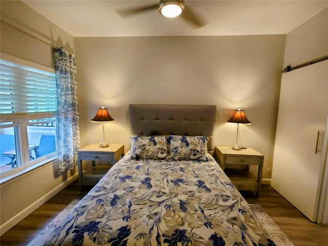 a bedroom with a bed and wooden floor