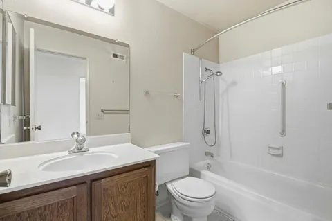 a bathroom with a sink a toilet and a large mirror