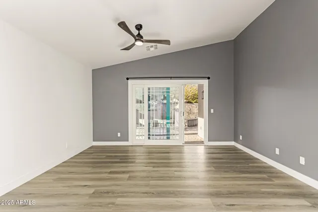 a kitchen with granite countertop a refrigerator and a stove top oven