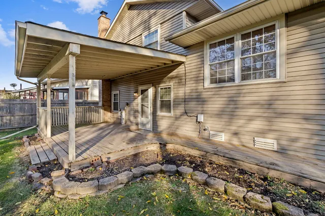 a view of a backyard with table and chairs