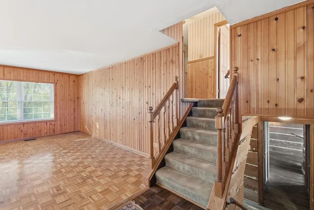 a view of entryway with wooden floor and stairs