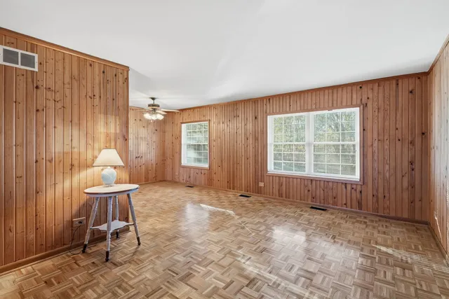 a very nice looking room with a large window and a chair