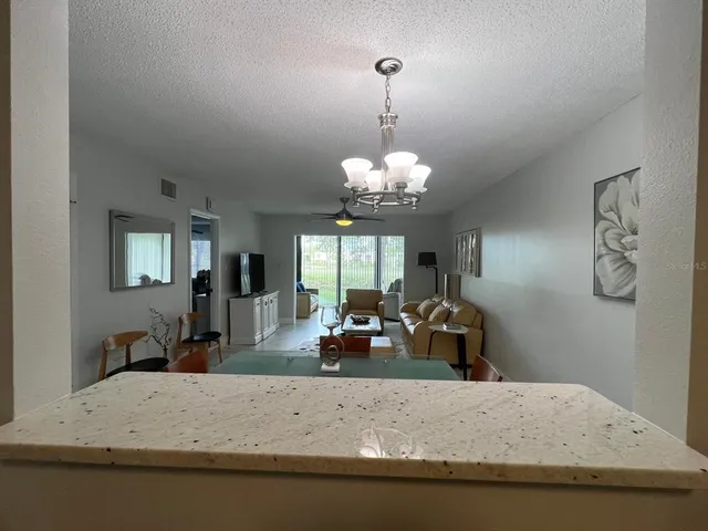 a view of a dining room with furniture and a chandelier