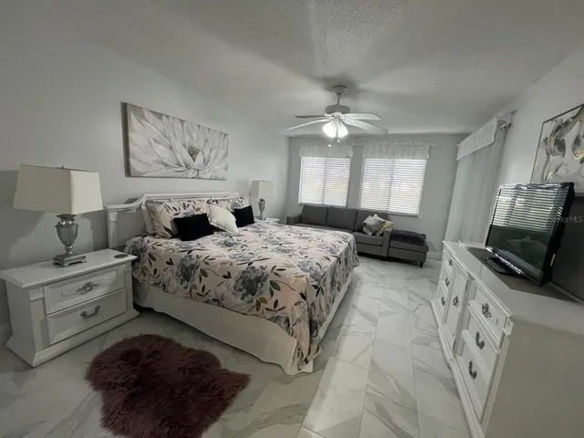 a bed sitting in a bedroom next to a window