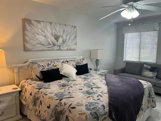 a bathroom with a granite countertop sink toilet and mirror