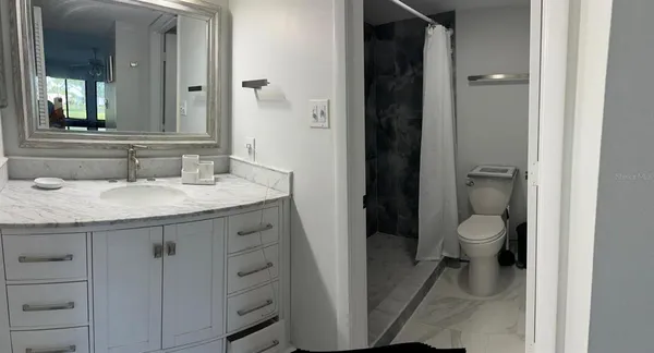 a bathroom with a sink vanity and mirror