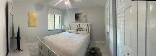 a bed sitting in a bedroom next to a window