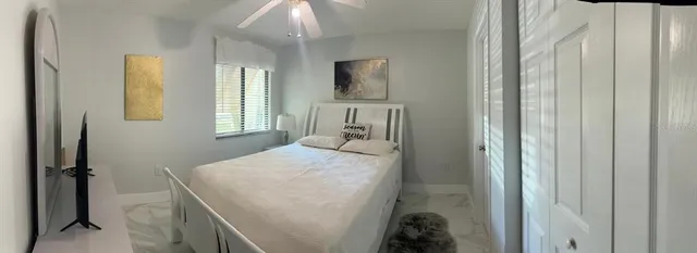 a bed sitting in a bedroom next to a window