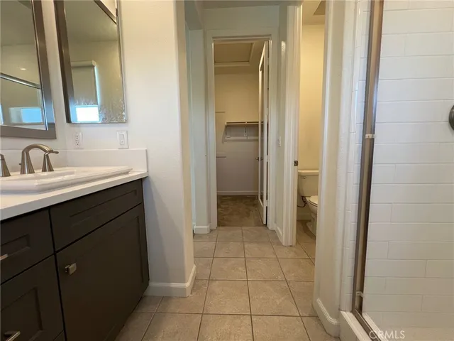 a bathroom with a sink a toilet and mirror