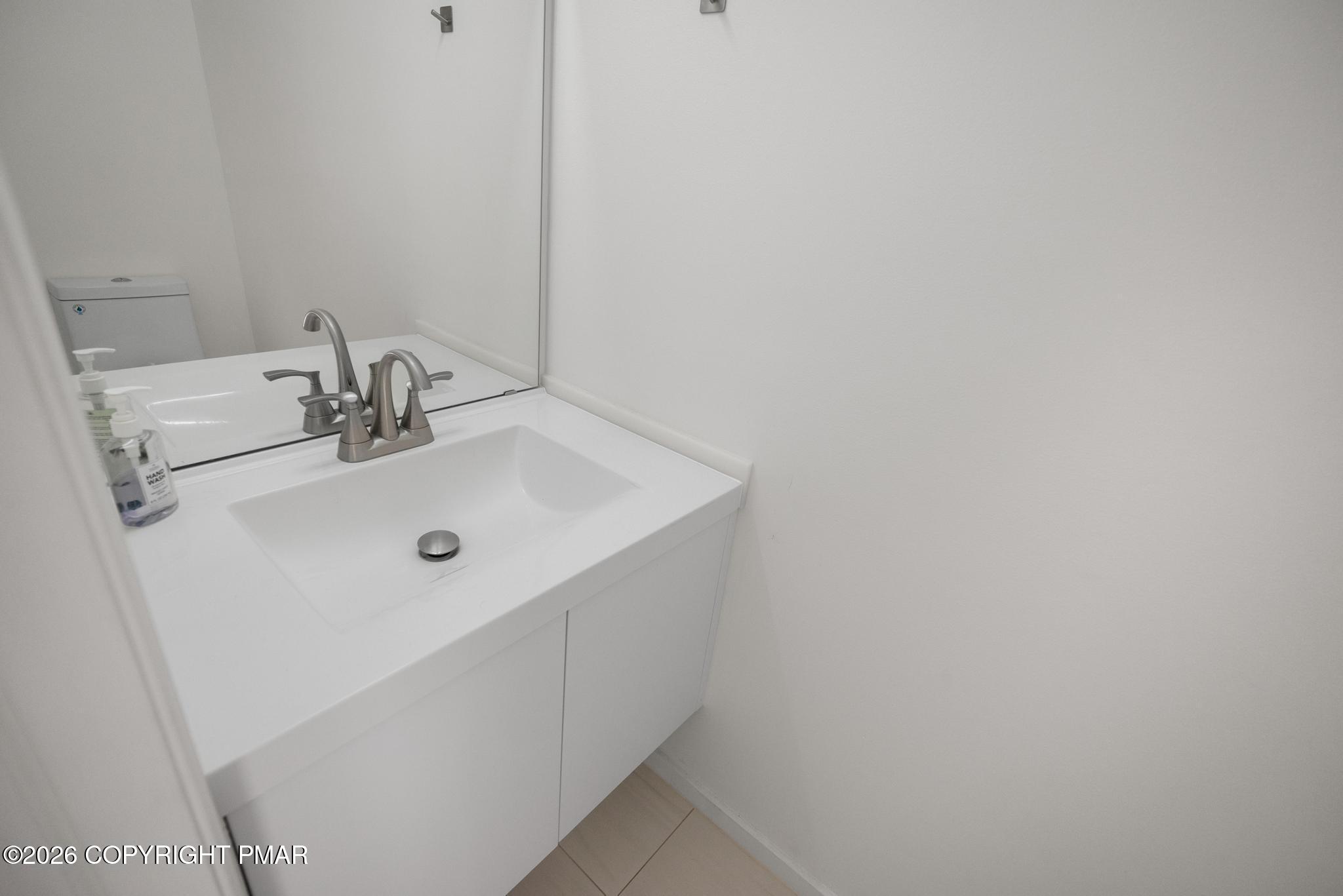 2312 Cramer Court Bushkill, PA 18324 - Photo 21 of 37 a bathroom with a sink and mirror