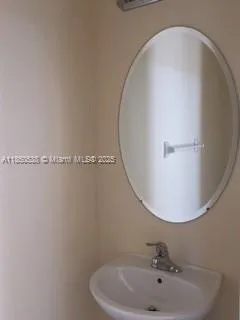 a bathroom with a sink and mirror