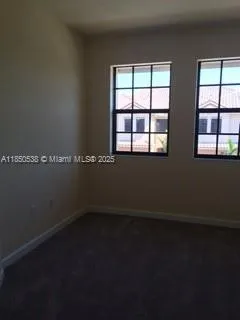 a view of a room with wooden floor and a window