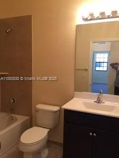 a bathroom with a sink toilet and mirror