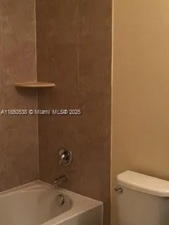 a bathroom with a shower and a sink