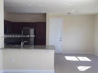 a kitchen with a sink and a refrigerator
