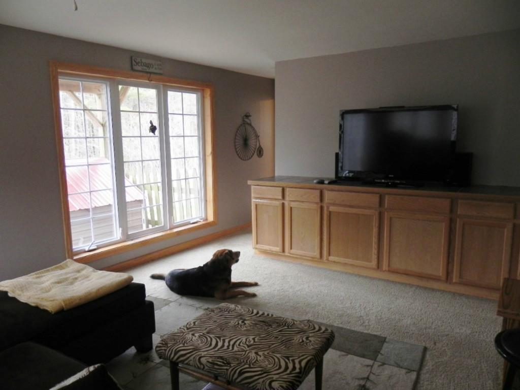 89 Peaked Mountain Road Sebago, ME 04029 - Photo 24 of 34 Family room in basement features...