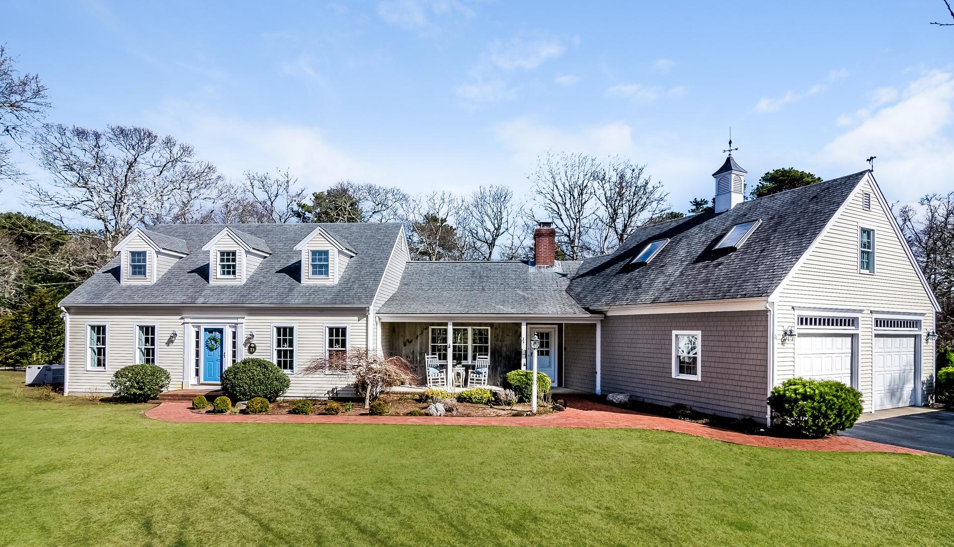 a front view of a house with yard and garage