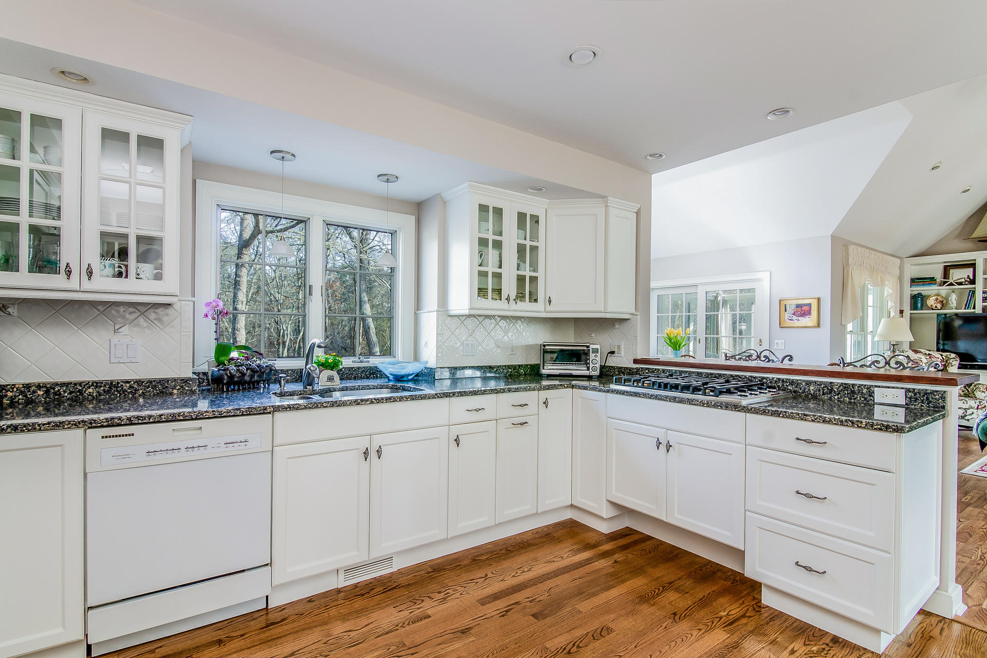 21 Marshview Lane Brewster, MA 02631 - Photo 12 of 37 a kitchen with granite countertop white cabinets sink and window