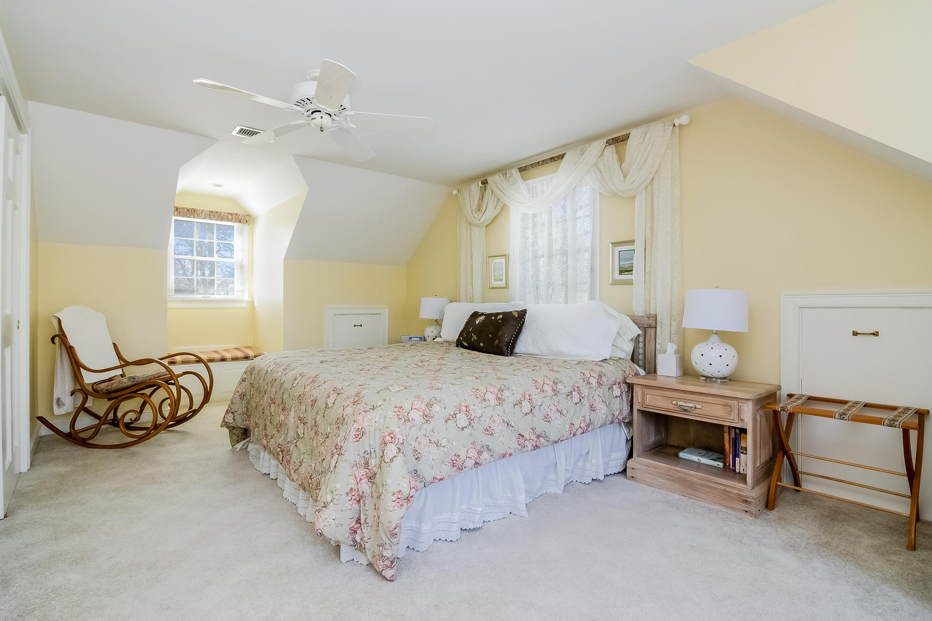 21 Marshview Lane Brewster, MA 02631 - Photo 22 of 37 a spacious bedroom with a bed and a chandelier
