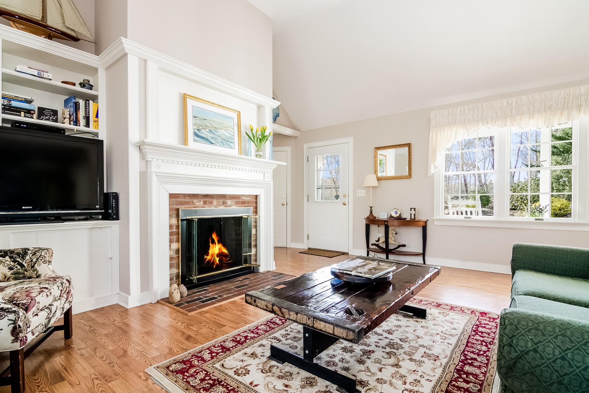 21 Marshview Lane Brewster, MA 02631 - Photo 4 of 37 a living room with furniture a flat screen tv and a fireplace