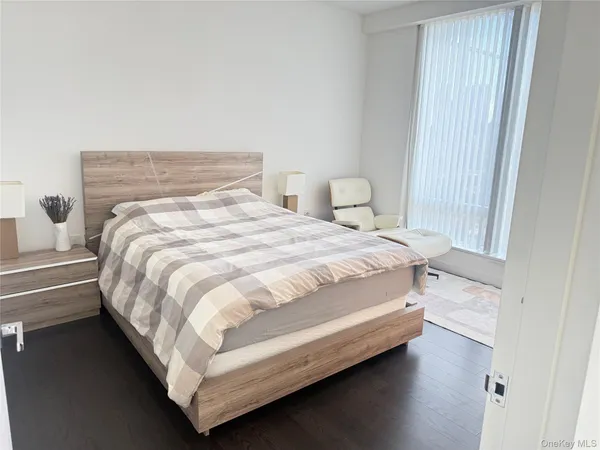 a bed sitting in a bedroom next to a window