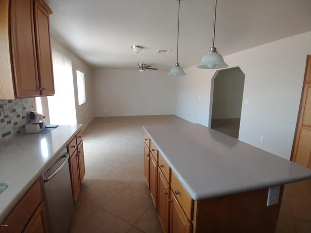 a kitchen with stainless steel appliances granite countertop a sink a refrigerator and a stove