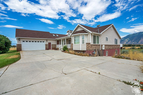 19 East Southfield Road Spanish Fork, UT 84660 - Photo 69 of 74 Ranch-style home with driveway, a garage, and a porch