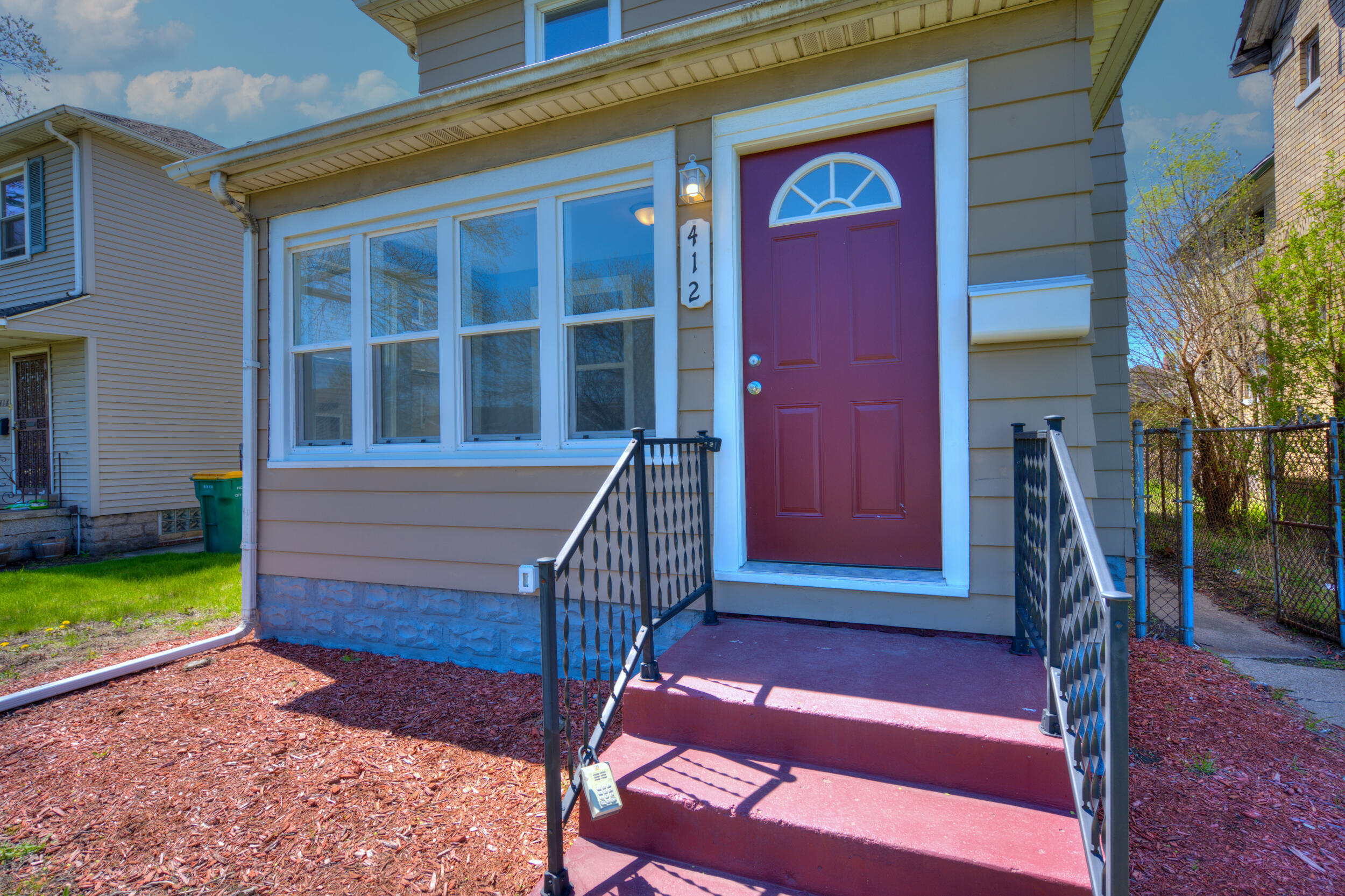 a view of front door of house with a yard