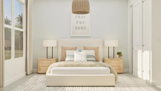 a bedroom with a bed a lamp and a large window