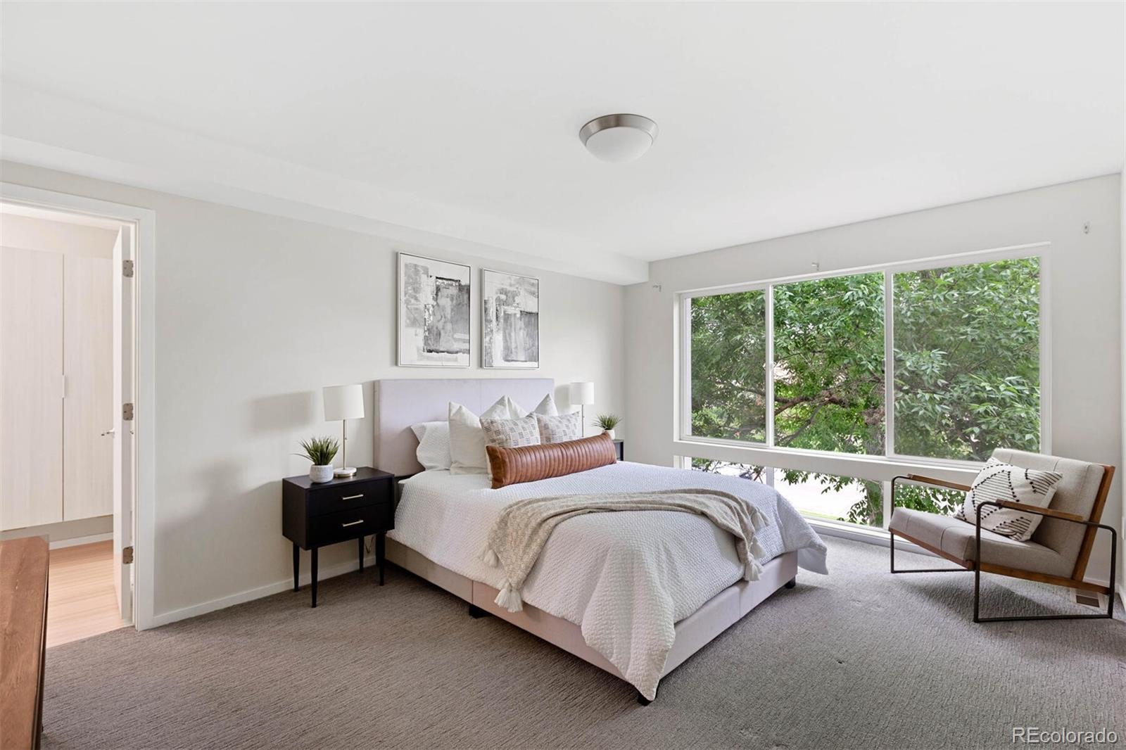 4011 Raleigh Street Denver, CO 80212 - Photo 15 of 34 a bedroom with a bed and a couch next to a window