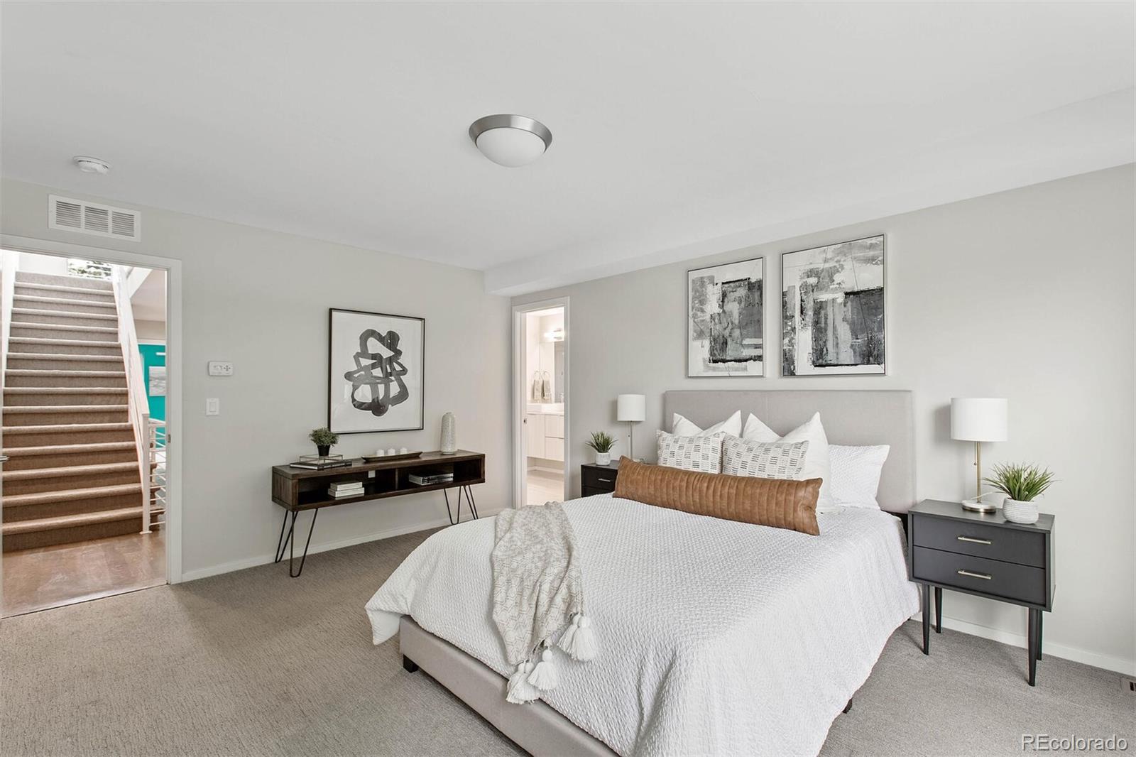 4011 Raleigh Street Denver, CO 80212 - Photo 16 of 34 a bedroom with a bed and a lamp on table