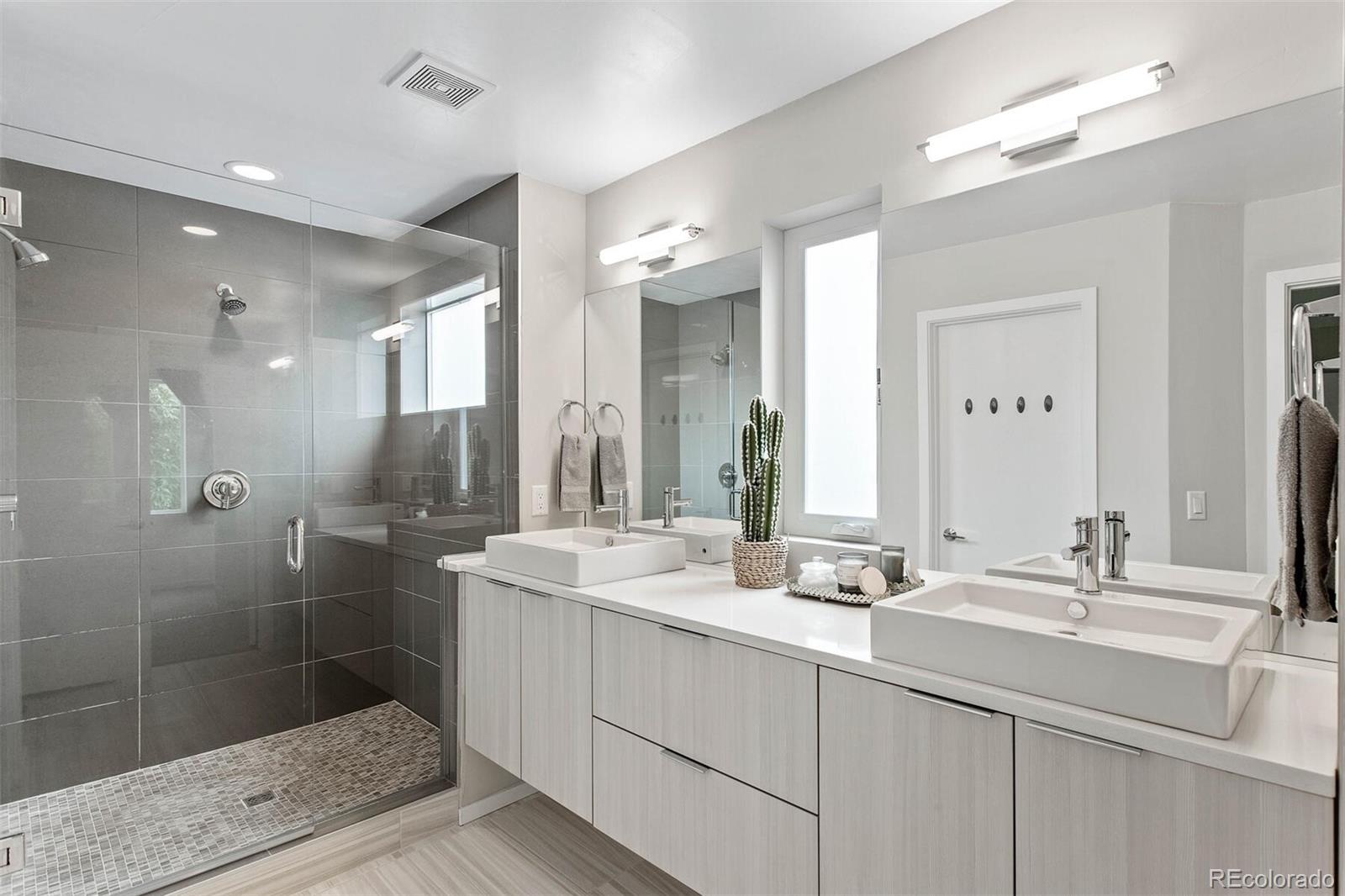 4011 Raleigh Street Denver, CO 80212 - Photo 17 of 34 a bathroom with a double vanity sink mirror and shower