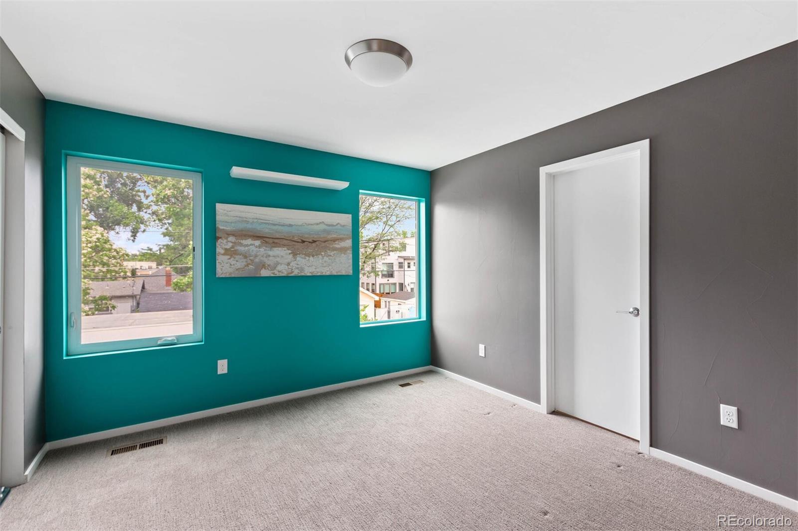 4011 Raleigh Street Denver, CO 80212 - Photo 18 of 34 a view of an empty room with a window and a kitchen