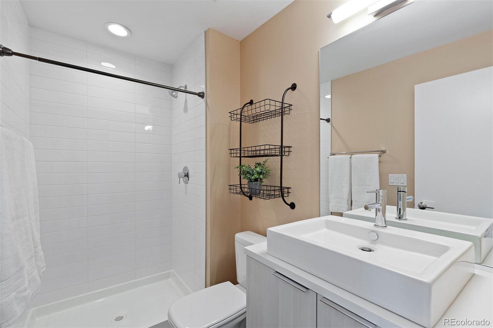 4011 Raleigh Street Denver, CO 80212 - Photo 29 of 34 a bathroom with a sink toilet and shower